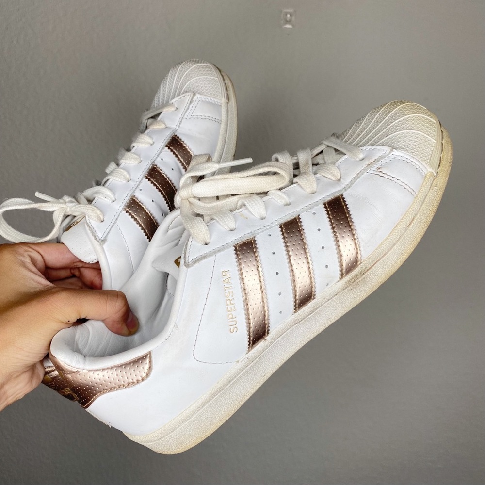 White and metallic gold Adidas superstars